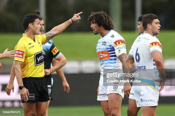 Kevin Proctor of the Titans is sent off by referee Henry Perenara for biting the forearm of Shaun Johnson of the Sharks during the round 14 NRL match...