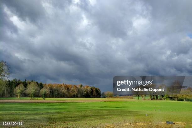 cloudy sky after the thunderstorm with a clearing in the countryside - bewolkt stockfoto's en -beelden