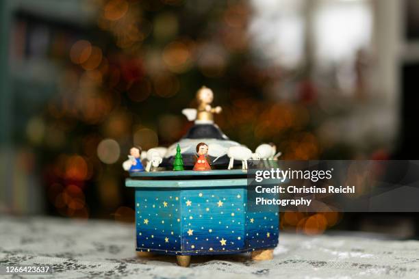 music box in front of christmas tree - music box stock pictures, royalty-free photos & images