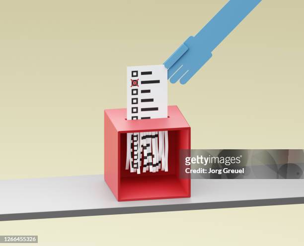 ballot being shreddered inside a ballot box - election fraud stock pictures, royalty-free photos & images