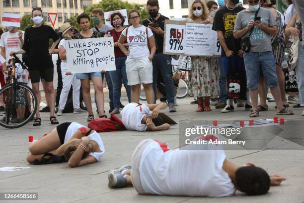 Protestors participate in a "Die-In" as they attend a demonstration against the results of Belarus' presidential election the previous weekend, in...