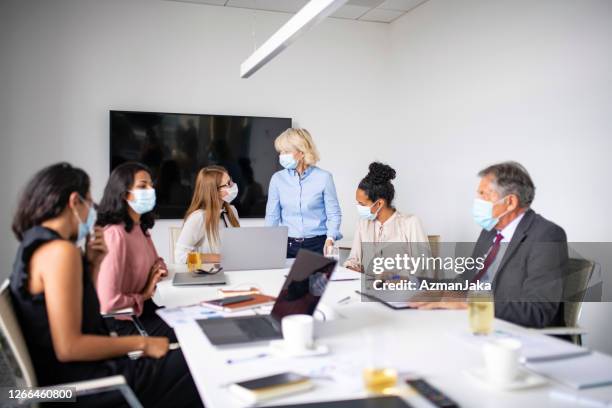 business colleagues wearing protective masks during meeting - business meeting with masks stock pictures, royalty-free photos & images