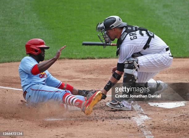Dexter Fowler of the St. Louis Cardinals is tagged out at the plate by Yasmani Grandal of the Chicago White Sox in the 1st inning at Guaranteed Rate...