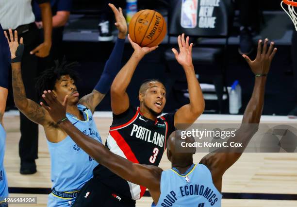 McCollum of the Portland Trail Blazers shoot against the Memphis Grizzlies and during the first quarter in the Western Conference play-in game one at...