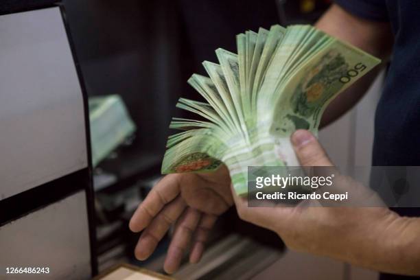 Detail as a worker separates the 500 Argentine peso notes before being sent to the final counting machine and quality control at Casa de Moneda on...