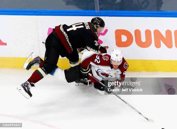 Carl Soderberg of the Arizona Coyotes checks Gabriel Landeskog of the Colorado Avalanche during the second period in Game Three of the Western...