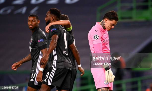 Ederson of Manchester City looks dejected as Moussa Dembele of Olympique Lyon celebrates after scoring his team's third goal during the UEFA...