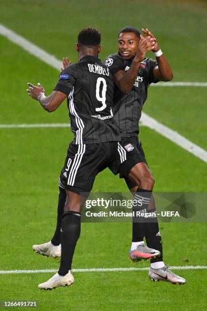 Moussa Dembele of Olympique Lyon celebrates with teammate Jeff Reine-Adelaide after scoring his team's third goal during the UEFA Champions League...