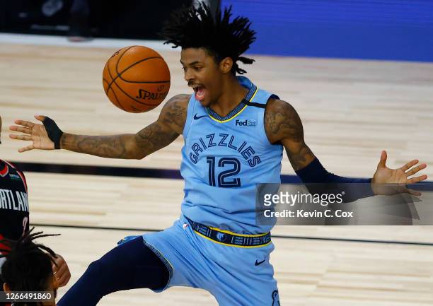 Ja Morant of the Memphis Grizzlies reacts after a dunk against the Portland Trail Blazers during the fourth quarter in the Western Conference play-in...