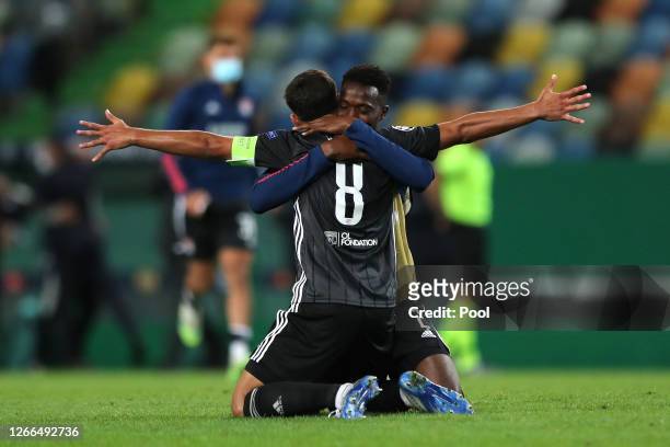 Sinaly Diomande and Houssem Aouar of Olympique Lyon celebrate following their team's victory in the UEFA Champions League Quarter Final match between...