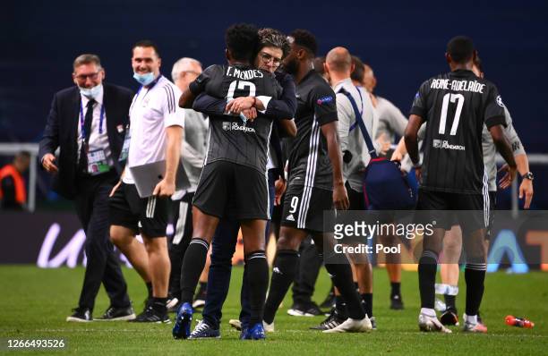 Juninho Pernambucano, Sporting Director of Olympique Lyon and Thiago Mendes of Olympique Lyon celebrate following their team's victory in the UEFA...