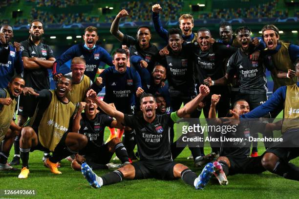 Houssem Aouar of Lyon celebrates with team mates after victory in the UEFA Champions League Quarter Final match between Manchester City and Lyon at...