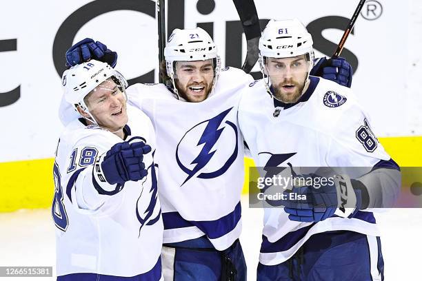 Brayden Point of the Tampa Bay Lightning is congratulated by his teammates, Ondrej Palat and Erik Cernak after scoring a goal against the Columbus...