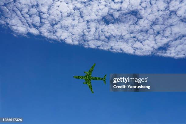 concept photo: one airplane flying in the sky,with beautiful cloud space - carbon neutrality stock pictures, royalty-free photos & images