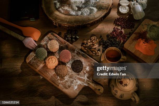 an asian chinese beautiful woman making chinese traditional mid-autumn snow skin mooncake at her kitchen - chuseok stock pictures, royalty-free photos & images