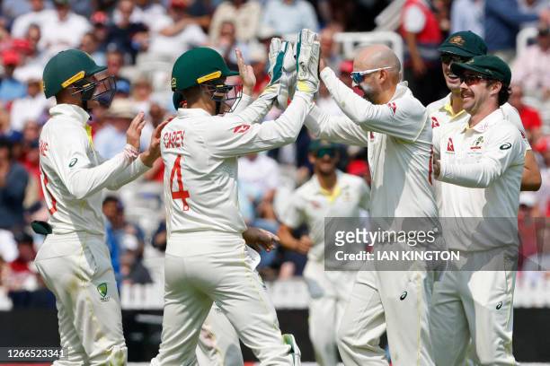 Australia's Nathan Lyon and Australia's wicket keeper Alex Carey celebrate after combining to dismiss England's Zak Crawley, stumped for 48 on day...