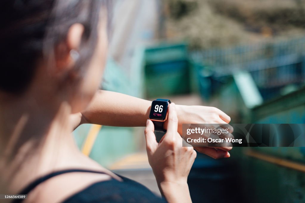 Young Woman Checking Heart Rate On Smart Watch