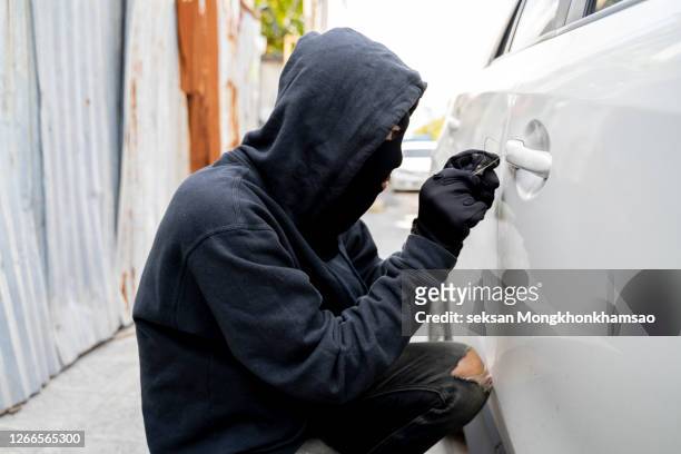 man stealing a car - hooligans stock pictures, royalty-free photos & images
