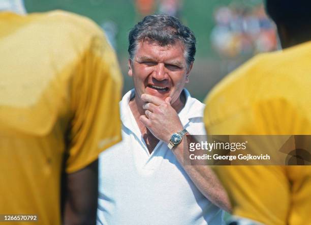 Assistant head coach George Perles of the Pittsburgh Steelers watches players practice during summer training camp at St. Vincent College in July...