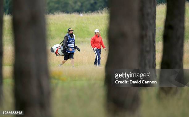 Harukyo Nomura of Japan walks to her second shot on the third hole with her caddie during the final round of the Aberdeen Standard Investments Ladies...