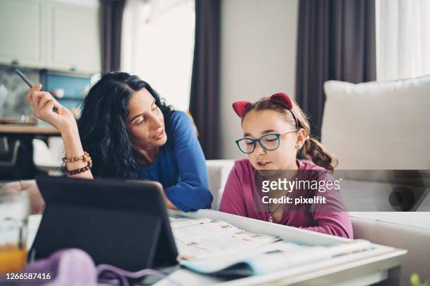 mother schooling her daughter - cat costume stock pictures, royalty-free photos & images