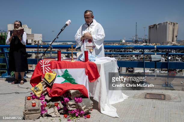 Father Michel Abboud, the President of Caritas Lebanon, conducts an open air mass in front of the destroyed Beirut port on August 16, 2020 in Beirut,...