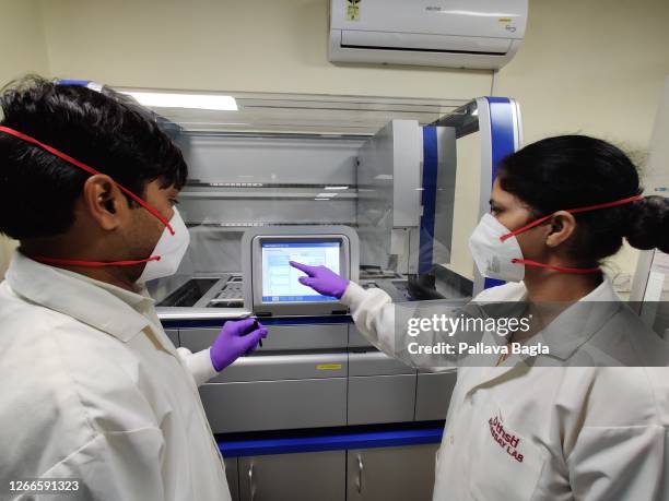 Researchers look at data on a screen on August 13,2020 at the Translational Health Science Technology Institute in Faridabad, India. India has ramped...