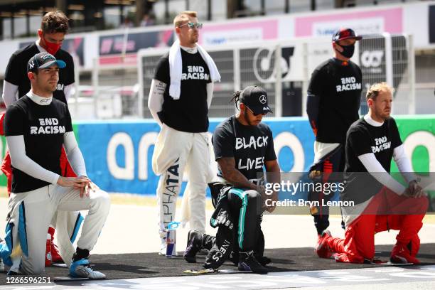 Nicholas Latifi of Canada and Williams, Lewis Hamilton of Great Britain and Mercedes GP and Sebastian Vettel of Germany and Ferrari take a knee on...