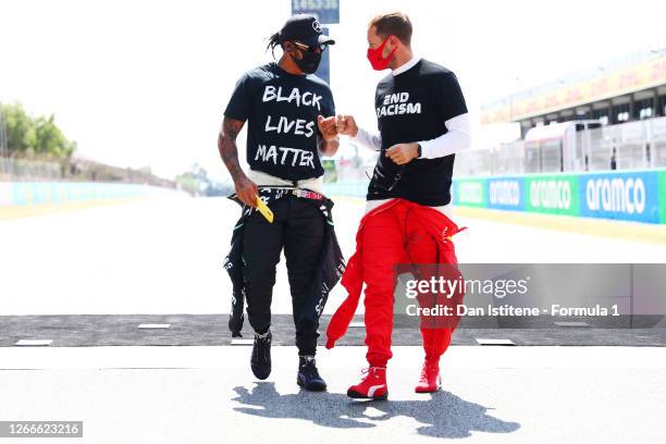 Lewis Hamilton of Great Britain and Mercedes GP and Sebastian Vettel of Germany and Ferrari talk on the grid before the F1 Grand Prix of Spain at...