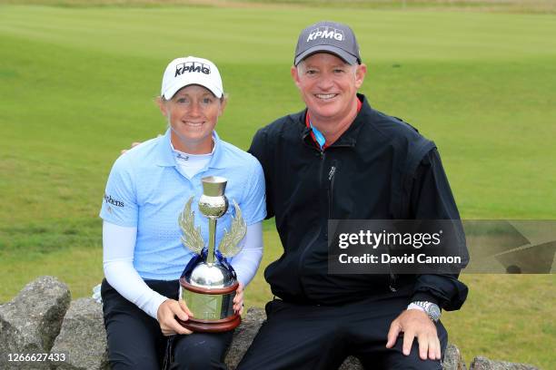 Stacy Lewis of The United States holds the trophy with her caddie Travis Wilson after her play-off win during the final round of the Aberdeen...