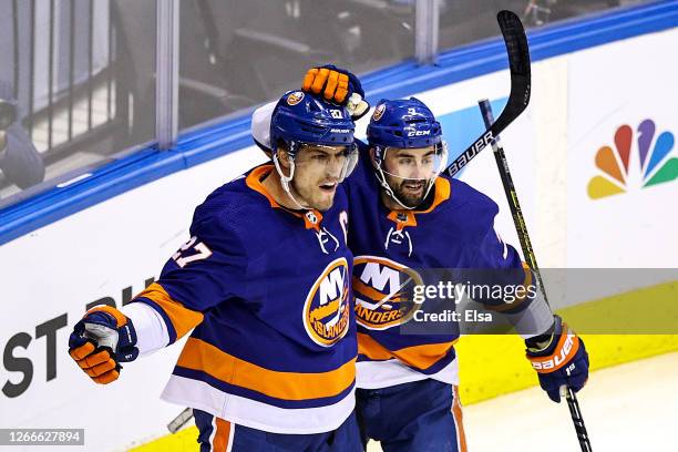 Anders Lee of the New York Islanders is congratulated by his teammate, Jordan Eberle after scoring a goal at 14:50 against the Washington Capitals...
