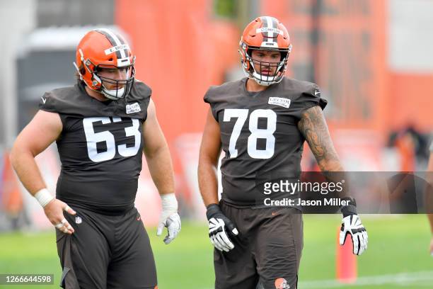 Evan Brown and Jack Conklin of the Cleveland Browns work out during training camp on August 16, 2020 at the Cleveland Browns training facility in...