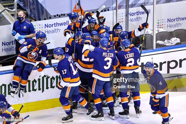 The New York Islanders celebrate the game winning goal by Mathew Barzal against the Washington Capitals during the first overtime period for a 2-1...