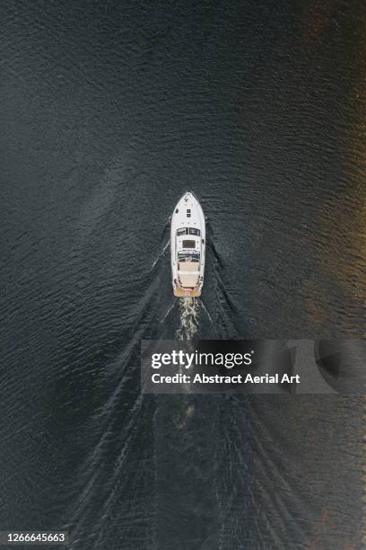 aerial shot above a leisure boat, loch ness, scotland, united kingdom - loch ness stock pictures, royalty-free photos & images