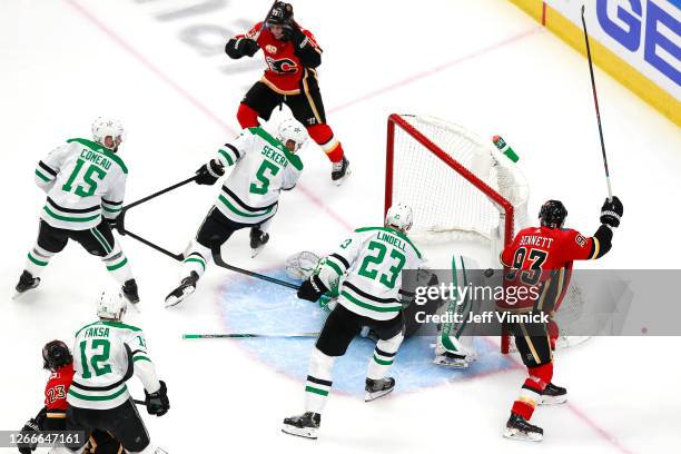 Johnny Gaudreau of the Calgary Flames celebrates with his teammates after scoring a goal on Anton Khudobin of the Dallas Stars during the second...