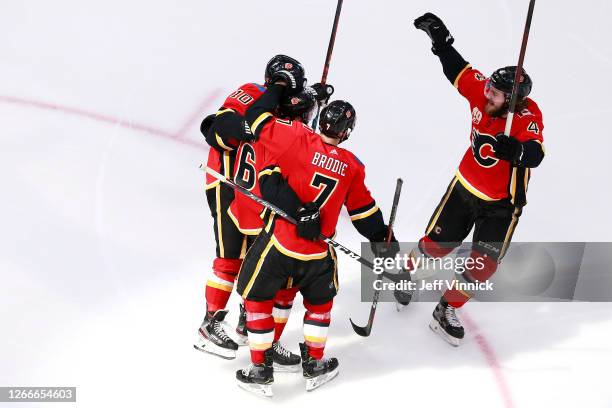 Tobias Rieder of the Calgary Flames celebrates with his teammates after scoring a goal on Anton Khudobin of the Dallas Stars during the third period...