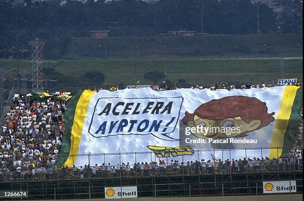 Fans hold a huge flag in support of Williams Renault driver Ayrton Senna of Brazil during the Brazilian Grand Prix at the Interlagos circuit in...