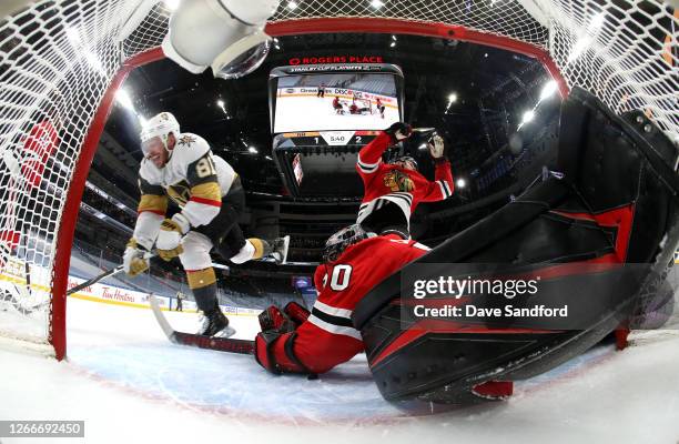 Jonathan Marchessault of the Vegas Golden Knights gets tripped up on an attempt on goaltender Corey Crawford of the Chicago Blackhawks during the...