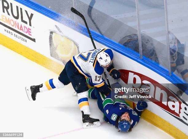 Jaden Schwartz of the St. Louis Blues checks Christopher Tanev of the Vancouver Canucks in Game Four of the Western Conference First Round during the...