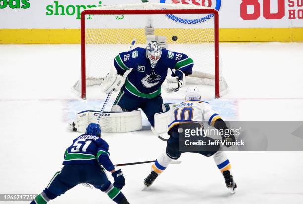 Brayden Schenn of the St. Louis Blues scores the game winning goal at 15:06 of overtime against Jacob Markstrom of the Vancouver Canucks in Game Four...
