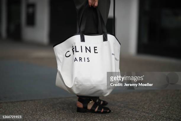 Maria Barteczko wearing Pixie Market grey pants, Asra black fisherman leather sandals, Celine oversized canvas tote bag on August 15, 2020 in...