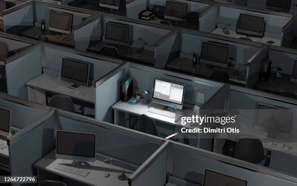 a computer screen lit up amongst others turned off in dark office - office cubicle stock-fotos und bilder