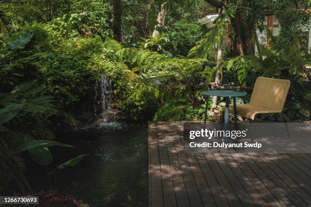 wooden terrace surrounded by greenery - composite decking stock pictures, royalty-free photos & images