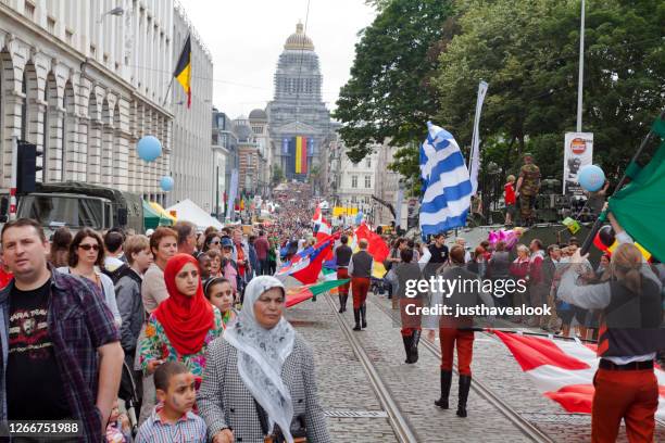 flag parade in crowd in brussels at national holiday - adult man brussels stock pictures, royalty-free photos & images