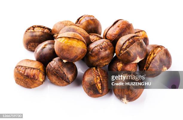 roasted chestnut on white background - maroni stock-fotos und bilder