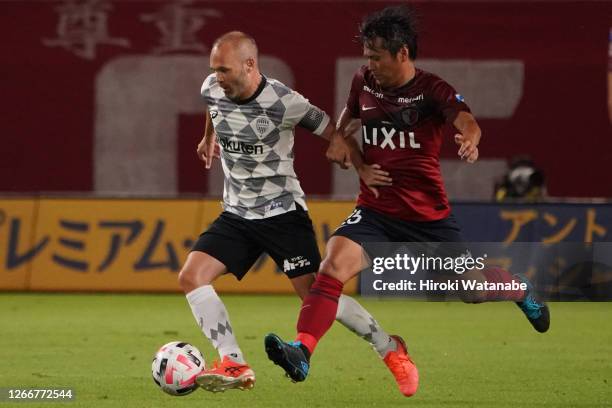 Yasushi Endo of Kashima Antlers and Andres Iniesta of Vissel Kobe compete for the ball during the J.League Meiji Yasuda J1 match between Kashima...