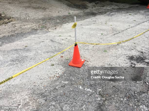 construction safety cone and caution tar creates a barrier - cordon boundary 個照片及圖片檔