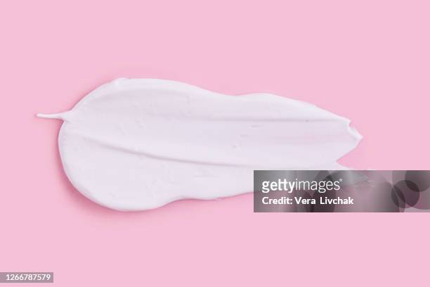 smear of natural moisturizer in pink background. cream, lotion for face or body. skin care. - creme stock-fotos und bilder