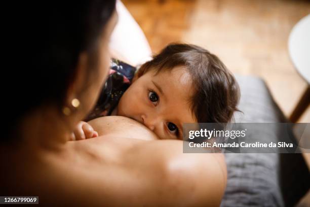 mother breastfeeding her baby - breastfeeding stock pictures, royalty-free photos & images