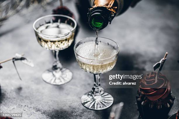 serving drinks for new years party - 2020 glasses stock pictures, royalty-free photos & images